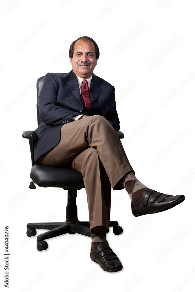 happy, confident senior businessman sitting in the office chair happy, confident senior businessman sitting in the office chair