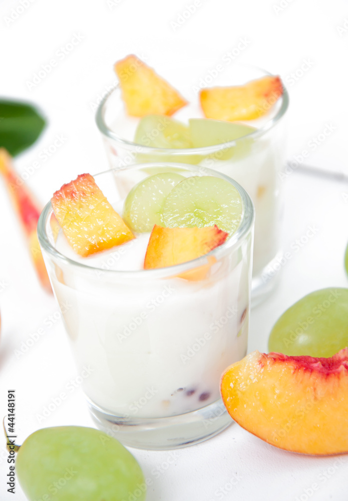 Fresh peach and grape yogurt in glass Fresh peach and grape yogurt in glass