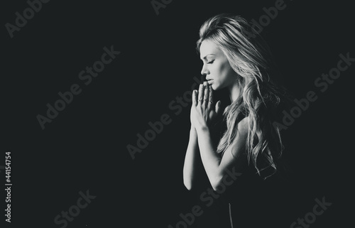 Stylized portrait of a beautiful girl in prayer