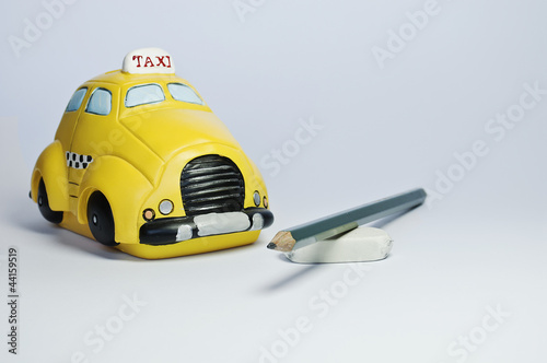 Taxi toy, pencil and rubber isolated on neutral background