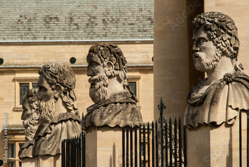 Four stone heads outside the Sheldonian theatre Oxford photo