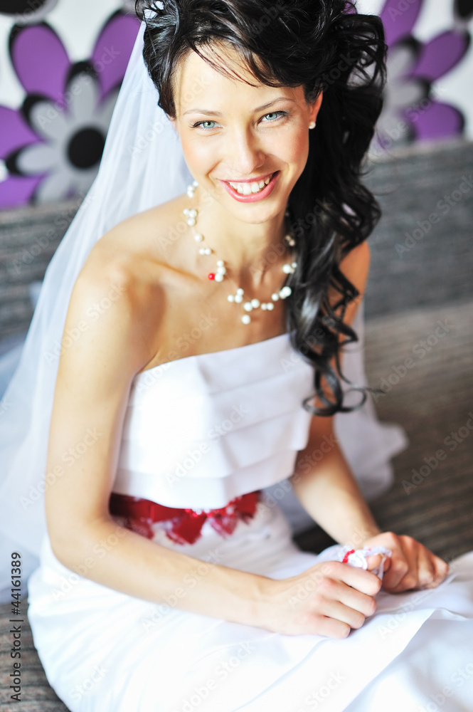 Fototapeta premium Young beautiful bride getting ready and smiling