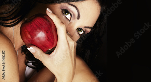 Mysterious woman holding red apple