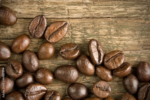 Coffee beans on the wooden vintage background