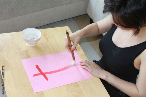 Japanese girl writing hiragana