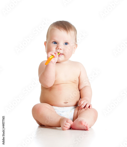 little baby with spoon over...