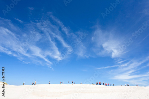people walking in the big dune, Slowinski National Park, Poland