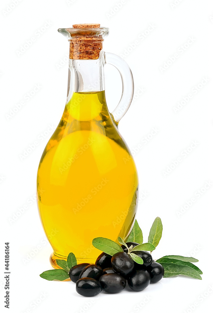 A jar with olive oil and some black olives A jar with olive oil and some black olives