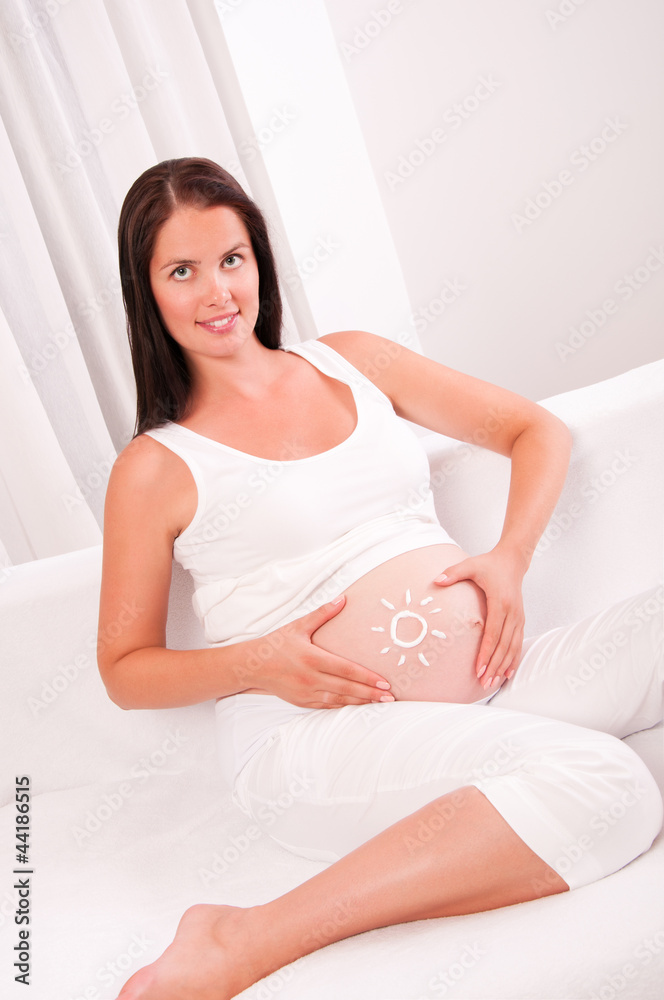 Pregnant woman on sofa at home Pregnant woman on sofa at home