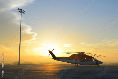 silhouette of helicopters on the apron