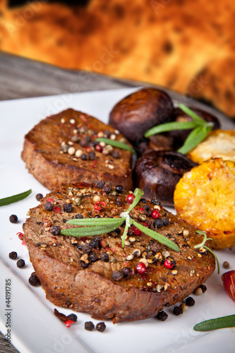 delicious grilled steak with vegetable on wooden table