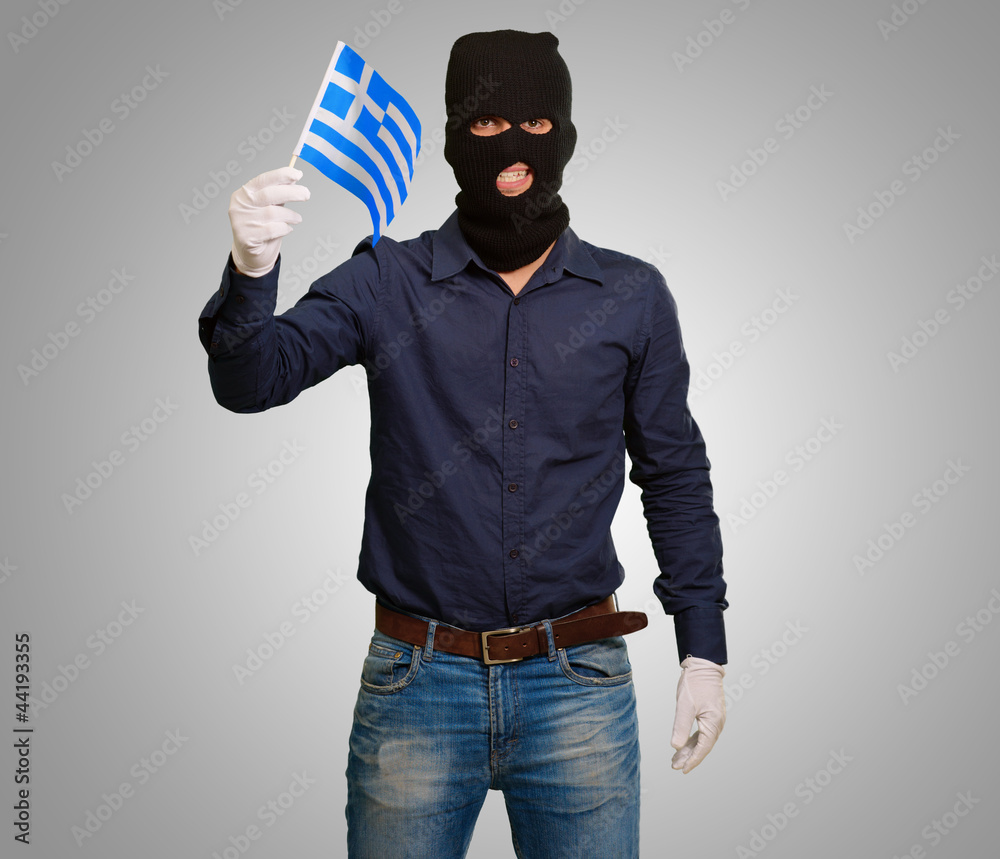 Man wearing robber mask and holding flag Man wearing robber mask and holding flag