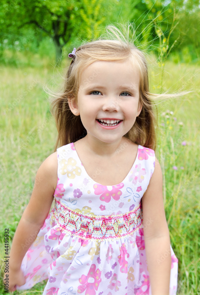Portrait of running little girl on the meadow Portrait of running little girl on the meadow