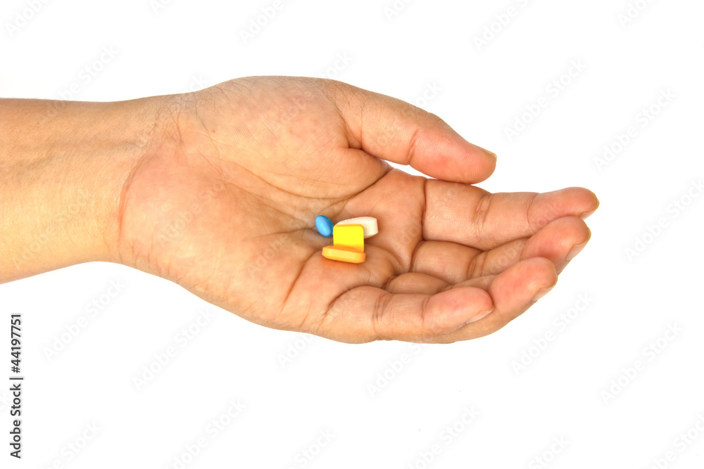 Pills in woman hand isolated on white background