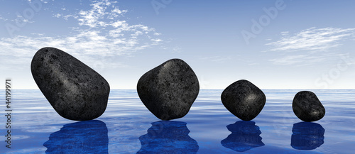 Photography Black stones on blue water