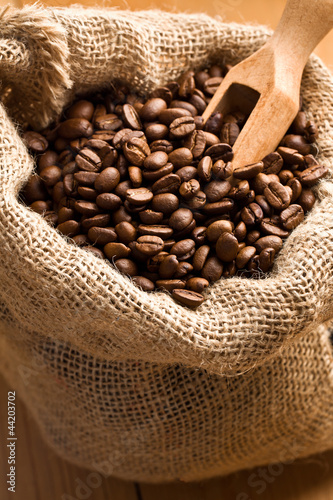Coffee beans in canvas sack with wooden scoop © Jiri Hera
