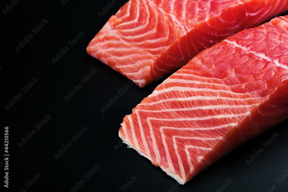 fresh salmon steak over black background fresh salmon steak over black background