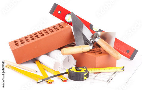 bricks,  mason tools and construction plans