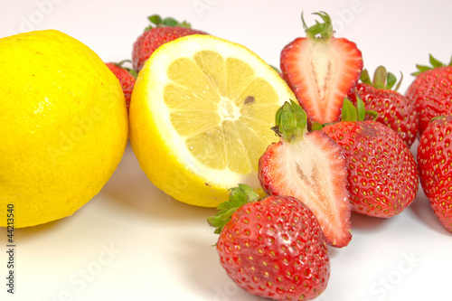 Lemons and strawberries on white