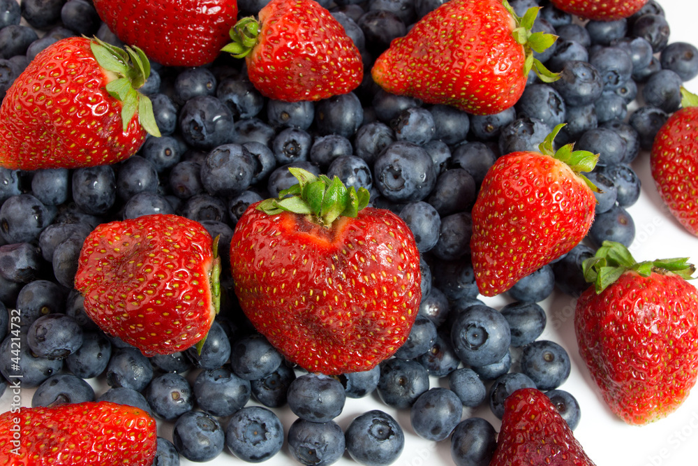Blueberries and strawberries on white Blueberries and strawberries on white