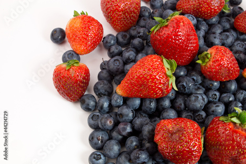 Blueberries and strawberries on white