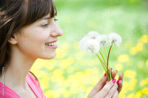 Young woman with dandelions