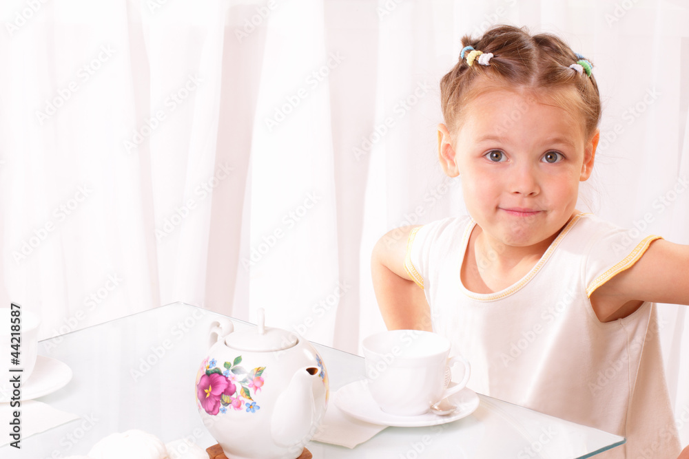 Beautiful little girl with a cup and teapot Beautiful little girl with a cup and teapot