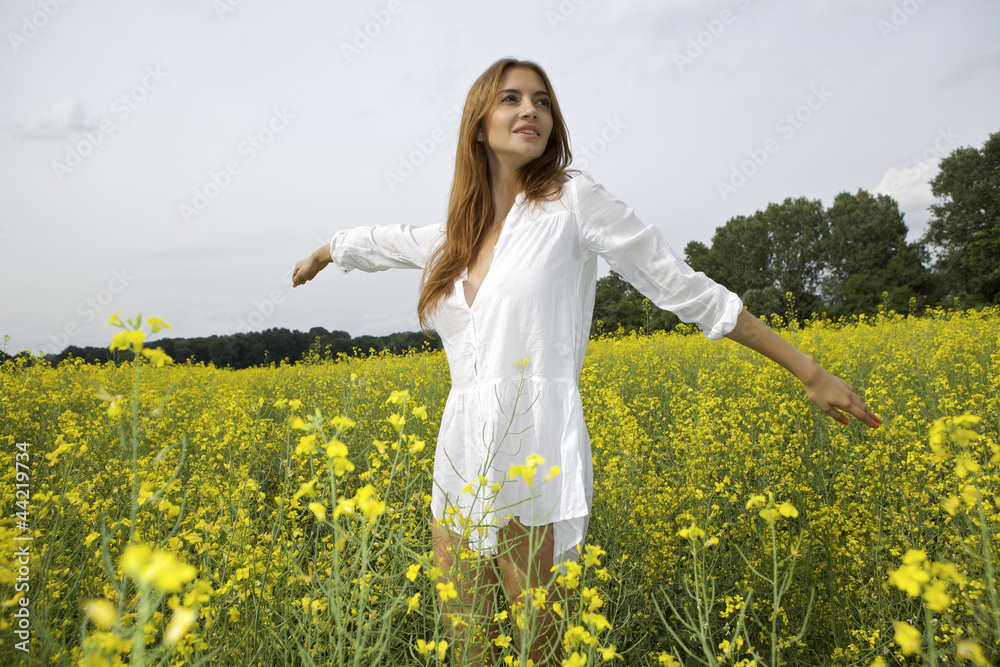 brunette woman in a yellow flowers field brunette woman in a yellow flowers field