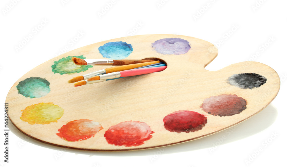 wooden art palette with paint and brushes isolated on white wooden art palette with paint and brushes isolated on white