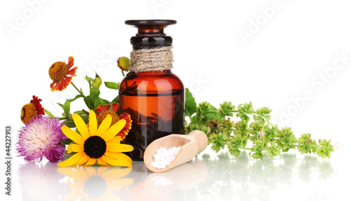 medicine bottle with tablets and flowers isolated on white