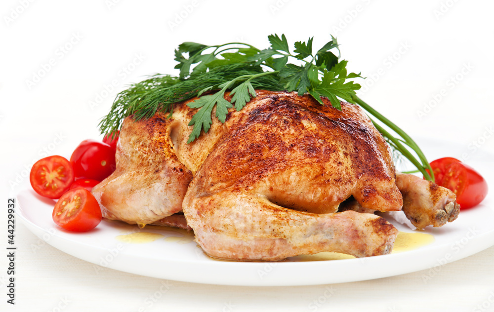 Whole roasted chicken with tomatoes and herbs on white backgroun Whole roasted chicken with tomatoes and herbs on white backgroun