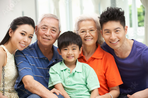 Portrait Of Multi-Generation Chinese Family Relaxing At Home