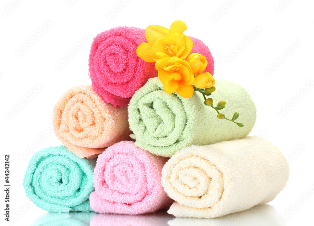 colorful towels and flowers isolated on white