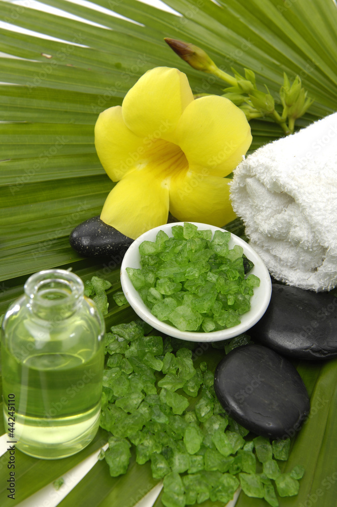 bath salts in bowl with massage oils and yellow orchid bath salts in bowl with massage oils and yellow orchid