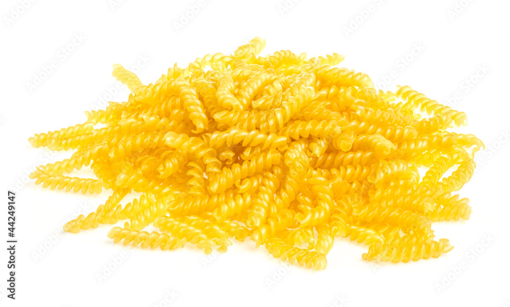 Fototapeta premium pile of fusilli pasta close up on wood background