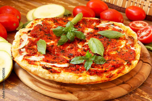 Baked pizza with tomatoes and zucchini