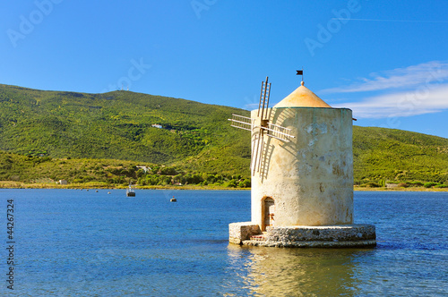 Old windmill in harbor of orbetello