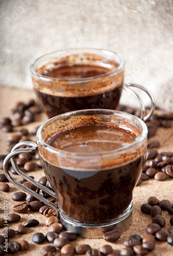 Fototapeta Naklejka Na Ścianę i Meble -  Two cups of black coffee on brown background 