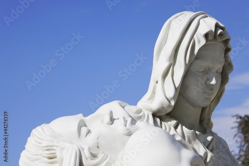 Religious Mary statue with blue sky background