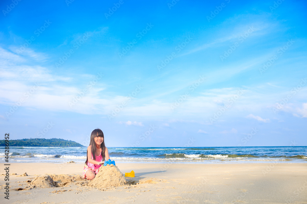 little girl playing on the beach