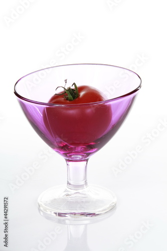 Red Tomato in pink glas photo