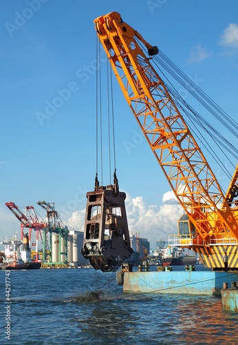 Dredger lifts Mud from Harbor Berth