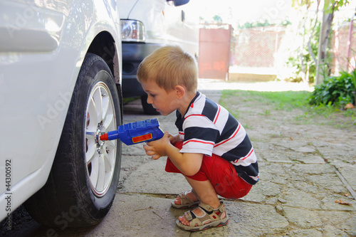 Lillte child playing in auto mechanic photo