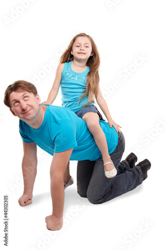 Father and little daughter in blue t-shirts play horse-ride