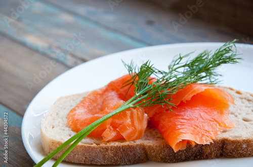 Smoked salmon on sourdough bread garnished with fresh dill.