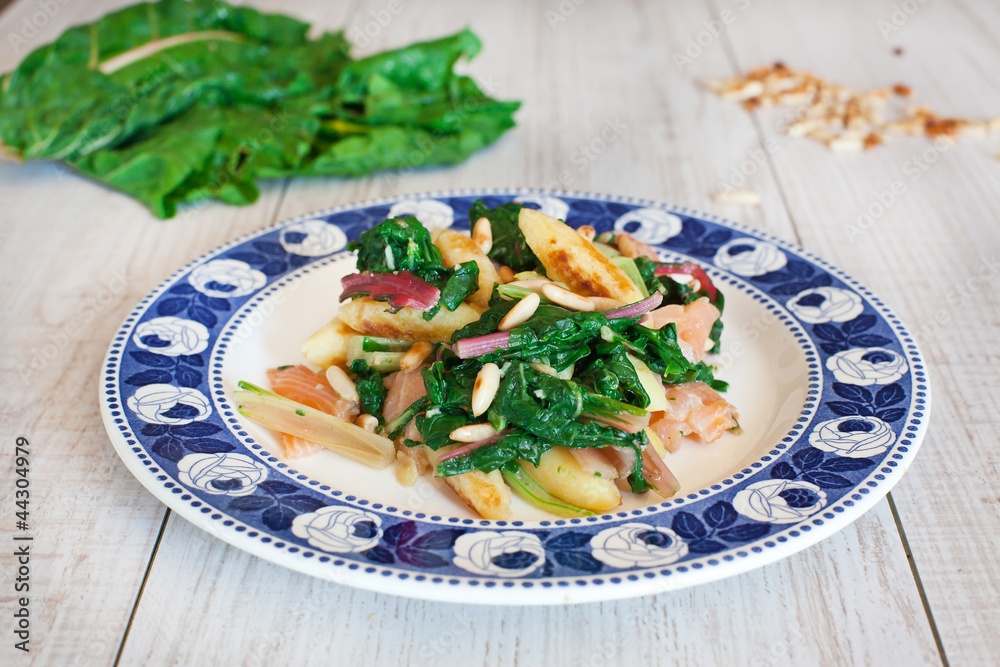 fresh salad with chard noodles and pine nuts on wooden table fresh salad with chard noodles and pine nuts on wooden table
