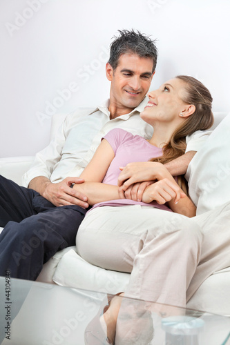 Relaxed Couple Sitting On Sofa