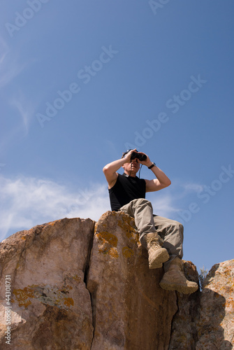 Man looks into binoculars