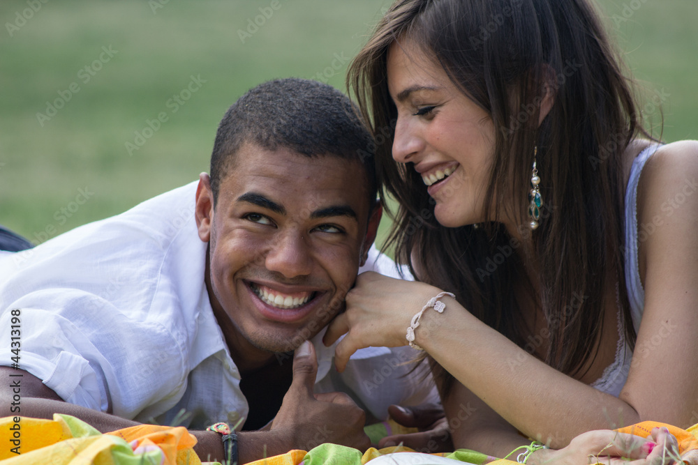 Young and smiling couple studying at the park