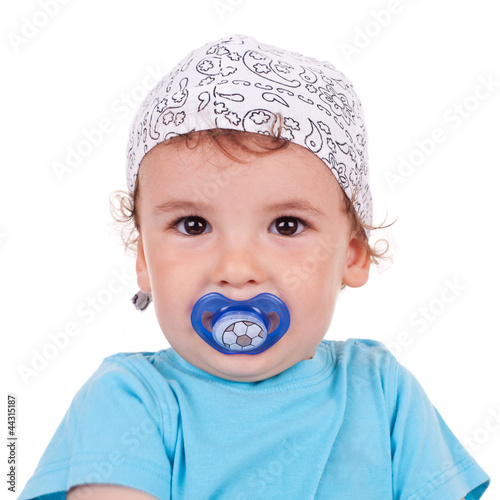 adorable little kid holding his pacifier
